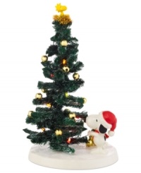 Woodstock is the star of Snoopy's expertly decked tree in this comical collectible from Peanuts Village, by Department 56. Woodstock is the star of Snoopy's expertly decked tree in this comical collectible from Peanuts Village, by Department 56.