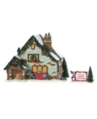 Home to the hardest working folks in Snow Village, the Elf House inspires merrymaking with lush garland, cheery red bows and twinkling lights. One of its residents holds a sign wishing guests a very merry Christmas. Home to the hardest working folks in Snow Village, the Elf House inspires merrymaking with lush garland, cheery red bows and twinkling lights. One of its residents holds a sign wishing guests a very merry Christmas.