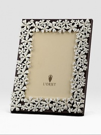 White Swarovski crystals shimmer on the platinum tone floral garland that surrounds this rich leather design.Holds 5 X 7 photoClassic beveled glassStretched leather backingGift boxedImported White Swarovski crystals shimmer on the platinum tone floral garland that surrounds this rich leather design.Holds 5 X 7 photoClassic beveled glassStretched leather backingGift boxedImported