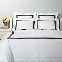A classic navy sateen border trims this elegant sham by SFERRA, woven from super soft Egyptian cotton. A classic navy sateen border trims this elegant sham by SFERRA, woven from super soft Egyptian cotton.