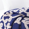Flowing with an air of whimsy, these knots dance off the duvet.