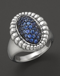 A fluted edge in sterling silver frames sparkling blue sapphires. From Lagos. A fluted edge in sterling silver frames sparkling blue sapphires. From Lagos.