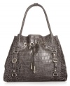 Every urban-jungle ensemble deserves exotic appeal, like this croc-embossed tote from Jessica Simpson. The spacious design is outfitted with gleaming hardware and buckle accents, while the interior flaunts multiple pockets for effortless on-the-go style.