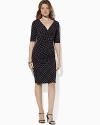 A charming print gives a chic graphic twist to a classic empire-waist dress in body-skimming matte jersey.