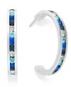 Traditions gives a sparkling boost to a simple pair of hoop earrings. A channel-set row of round-cut blue and clear Swarovski crystals shines within a sterling silver setting. Earrings feature a post and stud backing. Approximate diameter: 3/4 inch.