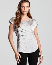 A metallic finish glams up the classic VINCE CAMUTO tee, while a studded sunburst punctuates the sleek silhouette for a tough take on femininity. A metallic finish glams up the classic VINCE CAMUTO tee, while a studded sunburst punctuates the sleek silhouette for a tough take on femininity.