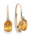Sparkling perfection. Add a vibrant pop of color to your look with oval-cut citrine (3/4 ct. t.w.) and sparkling diamond accents. Crafted in a 14k gold leverback setting. Approximate drop: 3/4 inch.