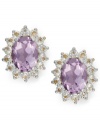 Enhance your look with bold flecks of color. Victoria Townsend's pretty stud earrings feature oval-cut amethyst (2-1/2 ct. t.w.) encircled by round-cut white topaz (1-1/20 ct. t.w.). Set in 18k gold over sterling silver. Approximate diameter: 1/2 inch.