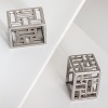 Dozens of square and rectangular cutouts give this napkin ring set from Natori a modern, dimensional look.