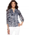 Jones New York Signature helps prep your wardrobe for spring with this vibrant petite blouse, featuring a navy and white animal print on a sheer, crinkled fabric. Pair with slim-fitting white pants for style that's spot on for the season. (Clearance)