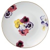 Pensees deep round dish by Bernardaud. This lively, luxurious collection is sure to transform your table into a celebration of spring. The floral watercolor pattern features delicate, multicolored pansies that appear to be strewn across the surface of each piece.