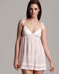 A whimsical babydoll with bow appliqués at straps and beaded trim along the hem. A whimsical babydoll with bow appliqués at straps and beaded trim along the hem.