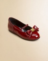 A dress-up favorite for every girl, shiny patent leather design topped with a classic bow and logo-embossed hardware.Patent leather upperHorizontal elastic top strapCheck printed padded insoleMan-made soleImported