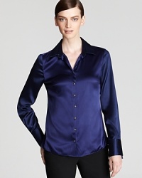 Make an unforgettable exit in a silk Elie Tahari blouse, flaunting a graphic print at the lower back for a thoroughly modern silhouette. Make an unforgettable exit in a silk Elie Tahari blouse, flaunting a graphic print at the lower back for a thoroughly modern silhouette.