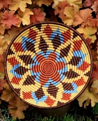 Inspired by the sun-drenched landscape of Rwanda, this meticulously handcrafted bowl rejuvenates decor with vibrant shades and geometric shapes. A thoughtful gift and striking accent piece for your wall or coffee table. Inspired by the sun-drenched landscape of Rwanda, this meticulously handcrafted bowl rejuvenates decor with vibrant shades and geometric shapes. A thoughtful gift and striking accent piece for your wall or coffee table.