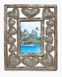 Much to love. This hand carved and hammered picture frame surrounds images of your favorite people with hearts of steel, but also gives hope to the artist, Johnny Simone, and other talented Haitians who depend on their craft. Much to love. This hand carved and hammered picture frame surrounds images of your favorite people with hearts of steel, but also gives hope to the artist, Johnny Simone, and other talented Haitians who depend on their craft.