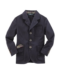 The three-button Langley sport coat is rendered in season-spanning cotton chino and finished with madras plaid lining the collar for a pop of preppy color. The three-button Langley sport coat is rendered in season-spanning cotton chino and finished with madras plaid lining the collar for a pop of preppy color.