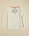 Juicy Couture indulges a flight of fancy, adding goldtone stud accents and a rhinestone bowtie to an elegant longsleeve top.