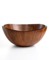 Naturally stunning and totally fresh, this curvy wooden bowl from The Cellar tops the table with easy modern style. Rich acacia wood stands alone or holds fruit, rolls and more.
