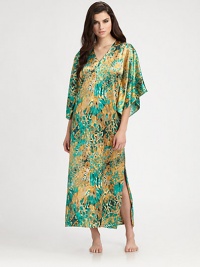 Lush florals brighten this silky-smooth design with wide, billowy sleeves. V-neckDropped shouldersThree-quarter length wide bell sleevesSide slits at hemAbout 53 from shoulder to hemPolyesterMachine washImported