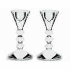 Fresh sculpted design comprising sharp edges and smooth planes. Their beauty is striking enough to stand alone, yet richly enhanced with the warm glow of candles. 5 3/8H vega candlestick, pair. Also available: 10 5/8H vega candlestick, each.