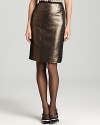 A sleek metallic finish lends rocker-luxe inspiration to an essential Tory Burch pencil skirt. Juxtapose the slim silhouette with a structured leather jacket for real modern edge.