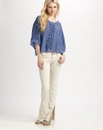 Fit-and-flare denim, slashed at the hem for a contemporary edge.Mid-rise waist Zip-fly Five-pocket style Flared leg Raw edges Inseam, about 33 98% cotton/2% elastane Machine wash Imported