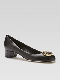 Lustrous leather pump fronted by an interlocking GG adornment. Stacked heel, 1½ (40mm)Leather upperLeather lining and solePadded insoleMade in Italy Lustrous leather pump fronted by an interlocking GG adornment. Stacked heel, 1½ (40mm)Leather upperLeather lining and solePadded insoleMade in Italy