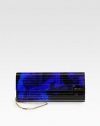 This rock n' roll-inspired acrylic clutch can be worn on the shoulder with a versatile chain strap. Detachable chain shoulder strap, 18¼ dropMagnetic snap closure on front flapOne inside open pocketSatin lining9½W X 4H X 1¼DMade in Italy
