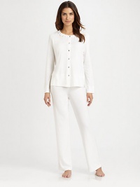 A dimensional ruffled neckline tops this ultra-cozy pajama set with simple buttons. JewelneckLong sleevesRuffled trim at necklineButton frontElasticized waistbandMercerized cottonMachine washImported A dimensional ruffled neckline tops this ultra-cozy pajama set with simple buttons. JewelneckLong sleevesRuffled trim at necklineButton frontElasticized waistbandMercerized cottonMachine washImported