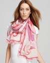 Floral shapes twist and turn down this elegant oblong scarf from Emilio Pucci.