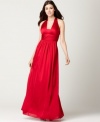 JS Boutique crafts a gown that's red-carpet worthy: With its ruched halter neckline, figure-flattering empire waist and long, floor-length silhouette, this gown is designed to steal the spotlight.
