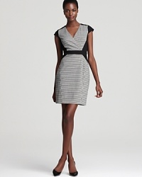 A classic gets a modern makeover on this Cynthia Steffe houndstooth dress with contrasting solid ponte panels. The body-con style flaunts a crossover neckline, cap sleeves and nipped waist to reveal your lithe silhouette.