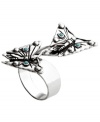 Beautiful butterflies emerge from this wrapped ring with delicate precision. Accented with bits of reconstituted turquoise this silver tone Fossil ring is made of mixed metal and comes in sizes 7 and 8.