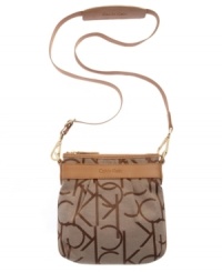 Signature jacquard fabric and supple leather trim create a contrasting colorblock effect on this compact, crossbody design by Calvin Klein. Discrete gold links, buckles and multi-purpose slip pockets make this the go-to bag for any occasion. Signature jacquard fabric and supple leather trim create a contrasting colorblock effect on this compact, crossbody design by Calvin Klein. Discrete gold links, buckles and multi-purpose slip pockets make this the go-to bag for any occasion.