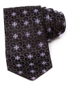 A subtle floral print takes form on luxe silk with this classic tie from Ike Behar.