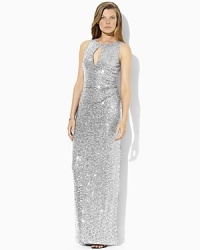 An elegant floor-length gown is rendered in glamorous sequined mesh with a keyhole cutout and graceful slit at the left side seam for added allure. An elegant floor-length gown is rendered in glamorous sequined mesh with a keyhole cutout and graceful slit at the left side seam for added allure.