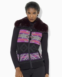 Rendered in a vibrant Fair Isle pattern, a cozy sweater vest is finished with luxe faux fur at the collar. Rendered in a vibrant Fair Isle pattern, a cozy sweater vest is finished with luxe faux fur at the collar.