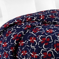 Moonlight silhouettes tropical dancing garlands on this DIANE von FURSTENBERG king duvet cover, in cool, soothing navy with red and white details.