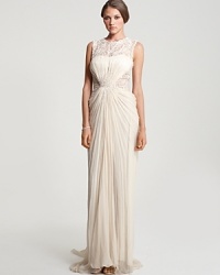 Capture attention in Tadashi Shoji's breathtaking embellished silk gown. A leaf-like lace pattern at the top is accented with shimmering beadwork for decadent appeal. Capture attention in Tadashi Shoji's breathtaking embellished silk gown. A leaf-like lace pattern at the top is accented with shimmering beadwork for decadent appeal.