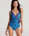An animal print in aquatic hues is trimmed in hot pink on a pool-ready, wrap front one piece from Gottex.