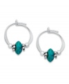 Petite hoop earrings with bright flecks of color. Jody Coyote's pretty style features simulated turquoise and silver beads set in sterling silver. Approximate diameter: 1/2 inch.