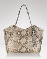 A haute bohemian tote from MICHAEL Michael Kors with gleaming hardware and decorative tassel detail in goes-with-everthing python leather. A haute bohemian tote from MICHAEL Michael Kors with gleaming hardware and decorative tassel detail in goes-with-everthing python leather.