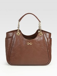 A roomy shape of ultra-rich pebbled leather, topped off with sleek chain handles and goldtone hardware. Leather and chain double top handles, 6¾ dropTwo outside open pocketsProtective metal feetOne inside zip compartmentOne inside zip pocketTwo inside open pocketsFully lined13¾W X 8¾H X 4¾DMade in Italy A roomy shape of ultra-rich pebbled leather, topped off with sleek chain handles and goldtone hardware. Leather and chain double top handles, 6¾ dropTwo outside open pocketsProtective metal feetOne inside zip compartmentOne inside zip pocketTwo inside open pocketsFully lined13¾W X 8¾H X 4¾DMade in Italy