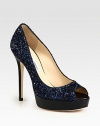 Shimmering peep toe silhouette of glittery fabric on an embossed leather platform and heel. Embossed leather heel, 5 (125mm)Embossed leather platform, ¾ (20mm)Compares to a 4¼ heel (110mm)Glitter-coated fabric upperPeep toeLeather lining and solePadded insoleMade in Italy