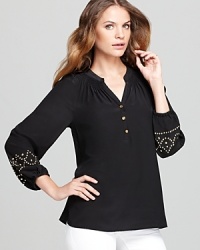 Enjoy a luxurious silhouette as luxe silk crafts an effortless Lilly Pulitzer blouse, finished with gold-tone beading at the cuffs for a touch of glamour. Enjoy a luxurious silhouette as luxe silk crafts an effortless Lilly Pulitzer blouse, finished with gold-tone beading at the cuffs for a touch of glamour.