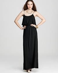 This Karen Kane maxi dress is flourished with ruffles at the neckline for an undeniably fun and feminine finish. A generous side vent ups the flirtatious factor. This Karen Kane maxi dress is flourished with ruffles at the neckline for an undeniably fun and feminine finish. A generous side vent ups the flirtatious factor.