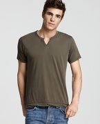 Regular-fit short-sleeve split-neck tee. Sleeves, neck and bottom hem are self-bound with loosely twisted, unfinished edges for a disheveled look.