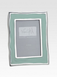 From the Como Collection. Inspired by the gentle ripples and soft hues of Italy's Lake Como, this enamel frame has wavy edges that add rich character to a favorite photo.Enamel over aluminumRed leather backHolds a 5 X 7 photoMade in USA From the Como Collection. Inspired by the gentle ripples and soft hues of Italy's Lake Como, this enamel frame has wavy edges that add rich character to a favorite photo.Enamel over aluminumRed leather backHolds a 5 X 7 photoMade in USA