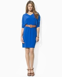 Designed for a flowing silhouette from figure-flattering stretch matte jersey, this dress features slimming ruched dolman sleeves, a V-neckline and a versatile braided leather belt for a stylish silhouette. Designed for a flowing silhouette from figure-flattering stretch matte jersey, this dress features slimming ruched dolman sleeves, a V-neckline and a versatile braided leather belt for a stylish silhouette.